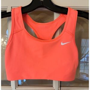 Women’s Nike Xs sports bra in a bright orange color, new with tags